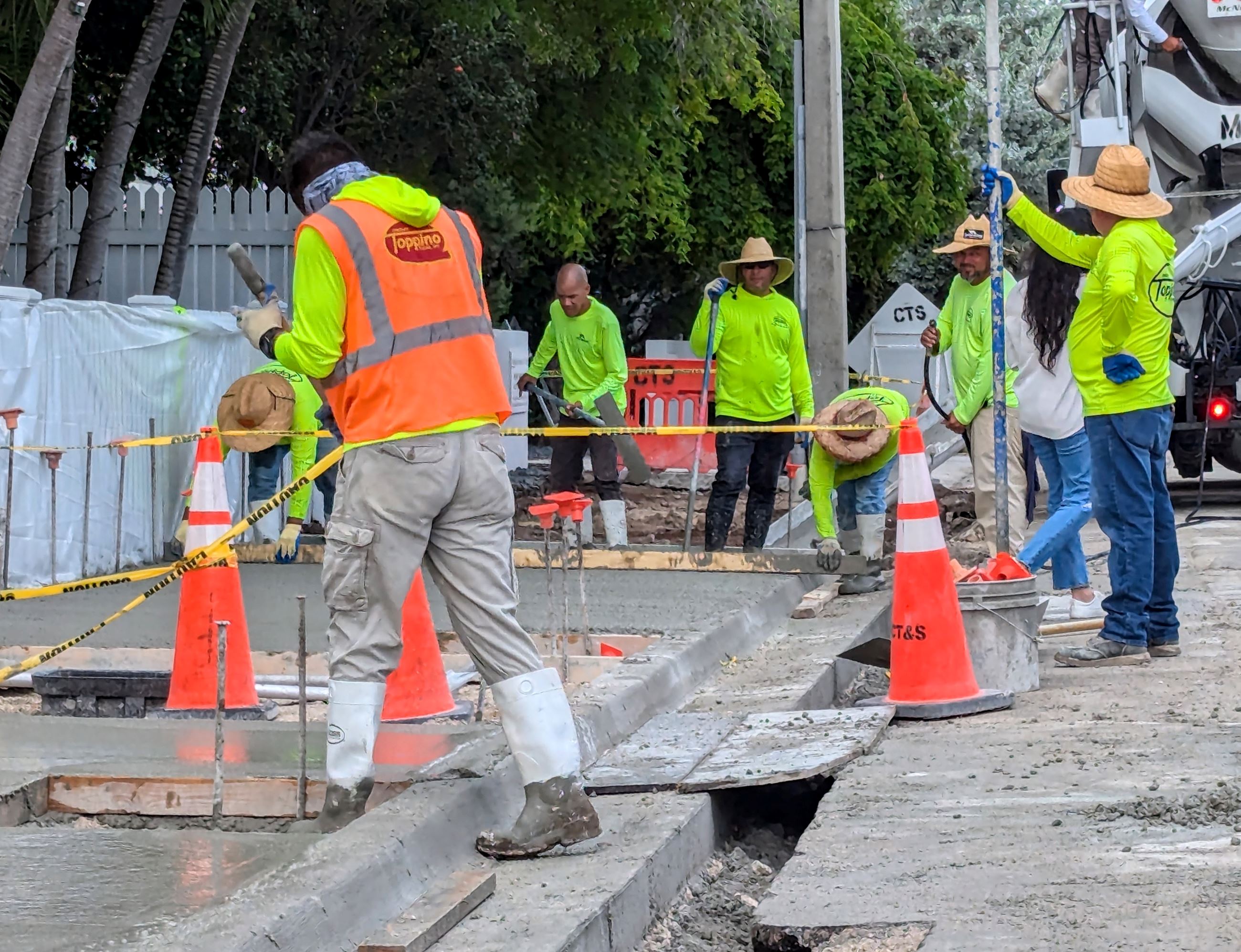 A group of workers pouring and finishing concrete